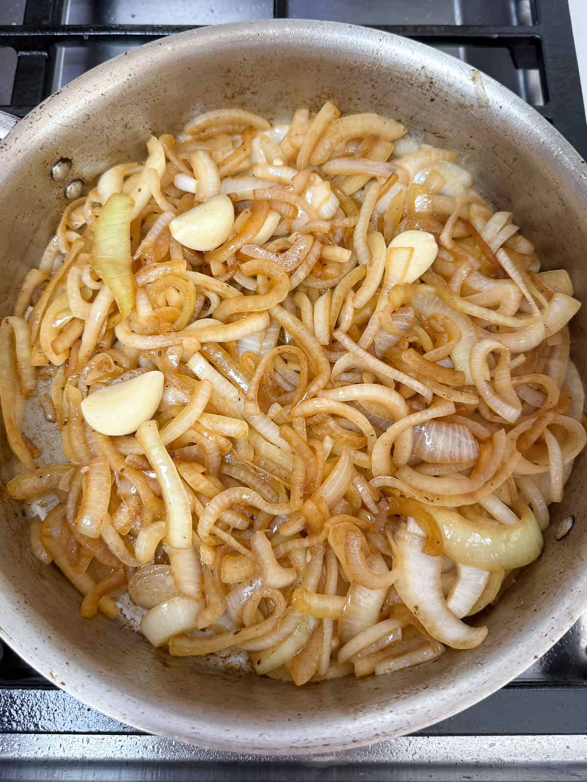Sauté the sliced onions until lightly golden.