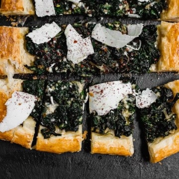 Savory chard tart with puff pastry and topped with shaved ricotta and sumac.
