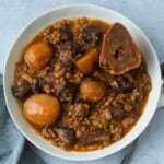 Traditional Jewish cholent with beef, beans, barley, and potatoes.