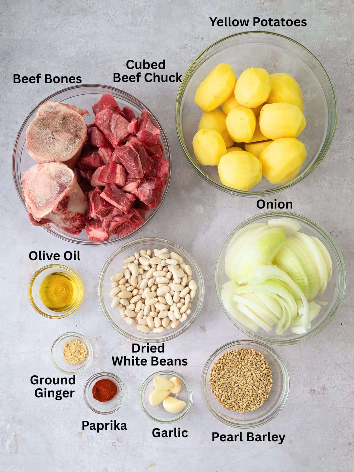 Ingredients for beef and bean cholent with potatoes, onions, pearl barley and spices.