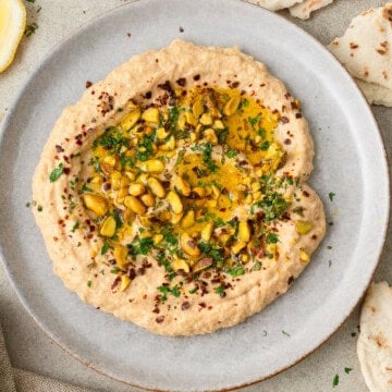 Smoky zucchini baba ghanoush topped with fresh mint, pistachios and olive oil.