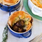 Beef Bourguignon pot pie with flaky puff pastry crust, tender beef, mushrooms, and pearl onions.
