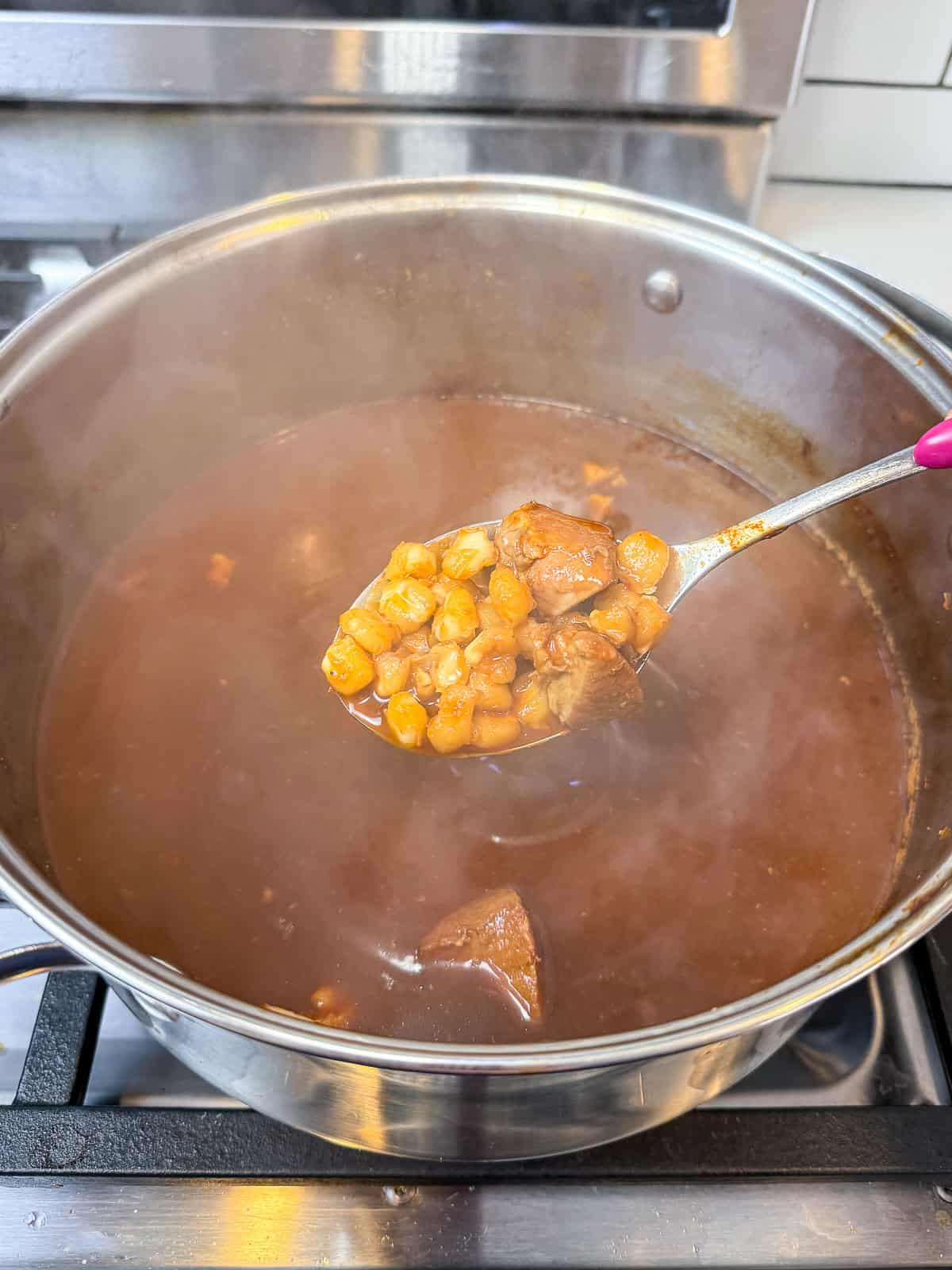 Add the hominy to the pozole and continue cooking until just tender.