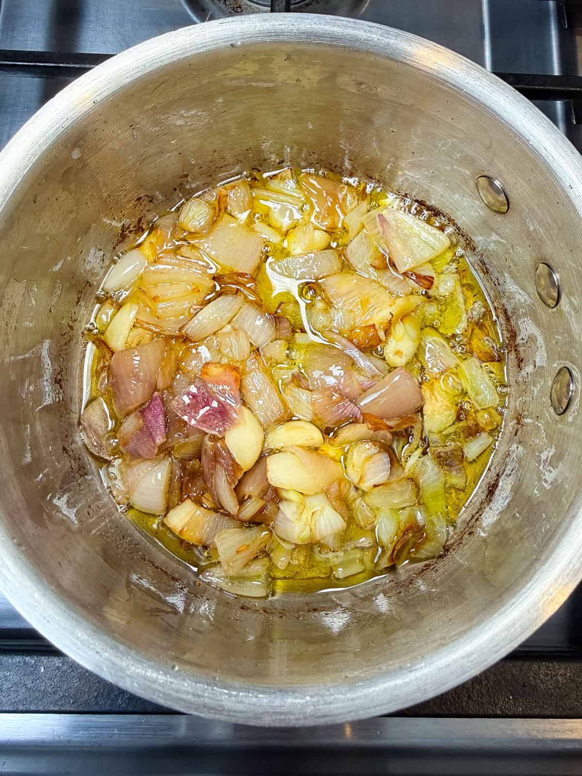 Sauté the shallots and garlic in olive oil until lightly caramelized around the edges.