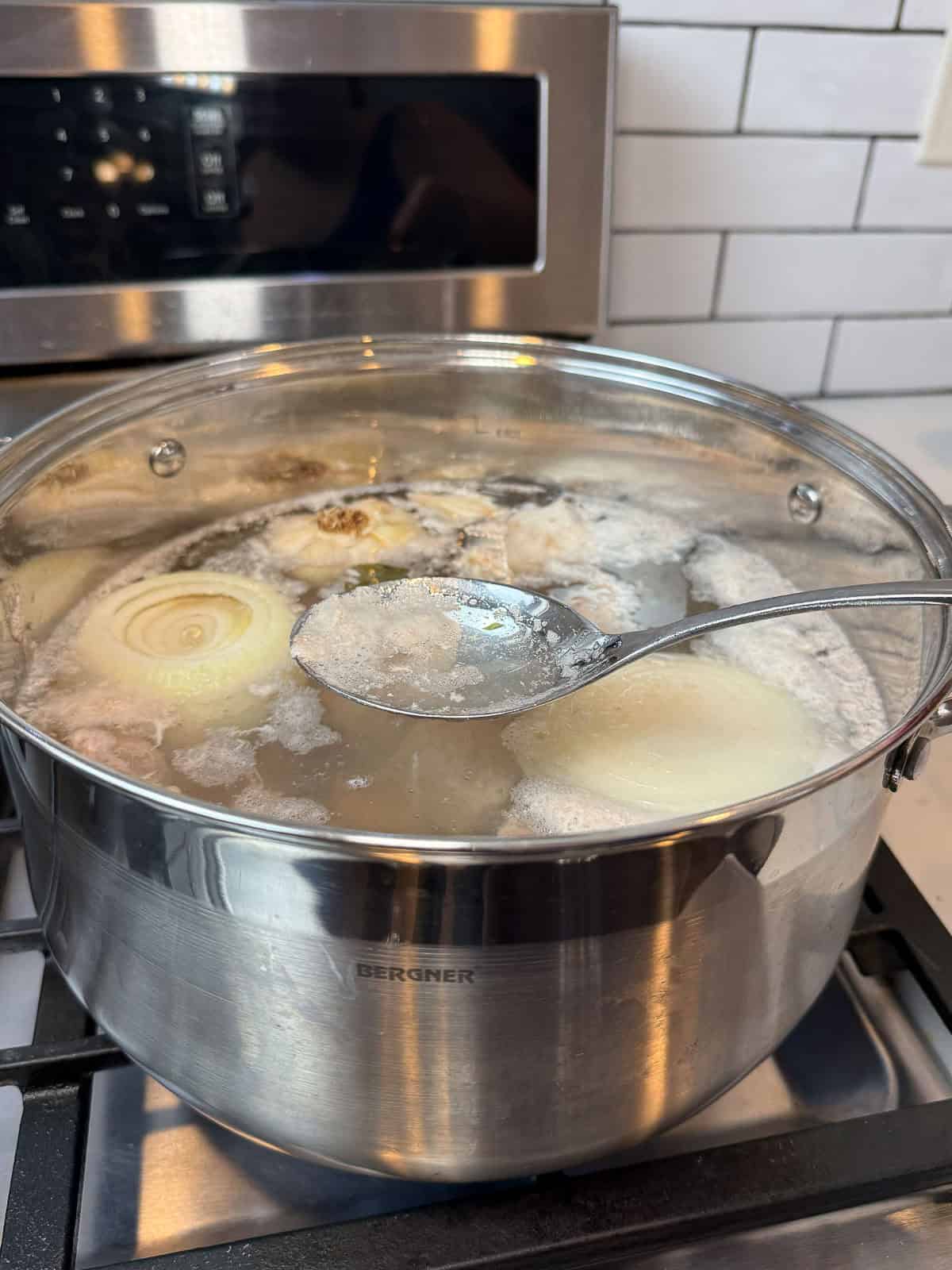 Skim the foam that settles to the surface of the pork stock.