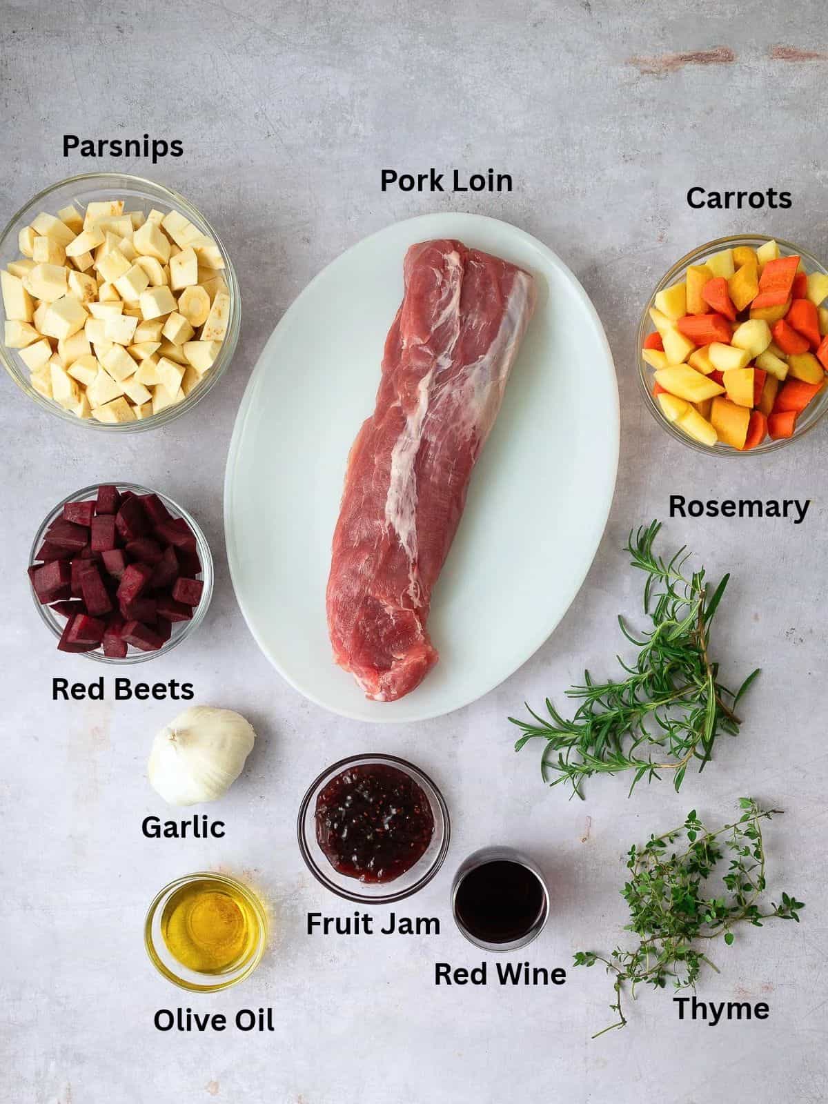 Ingredients for jam glazed pork loin, with root vegetables, fresh herbs, red wine and garlic.