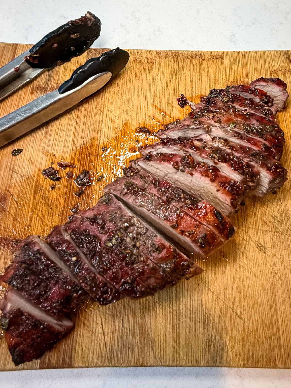 Once the jam glazed pork loin is roasted, let it rest for a few minutes before slicing.