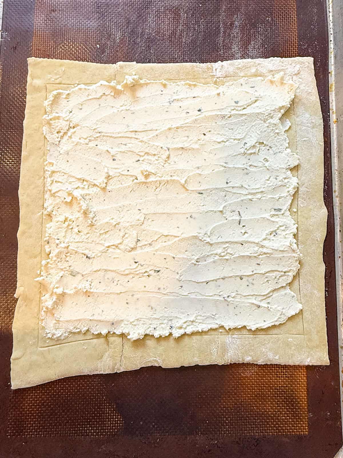 Spread Boursin cheese onto the thawed puff pastry.