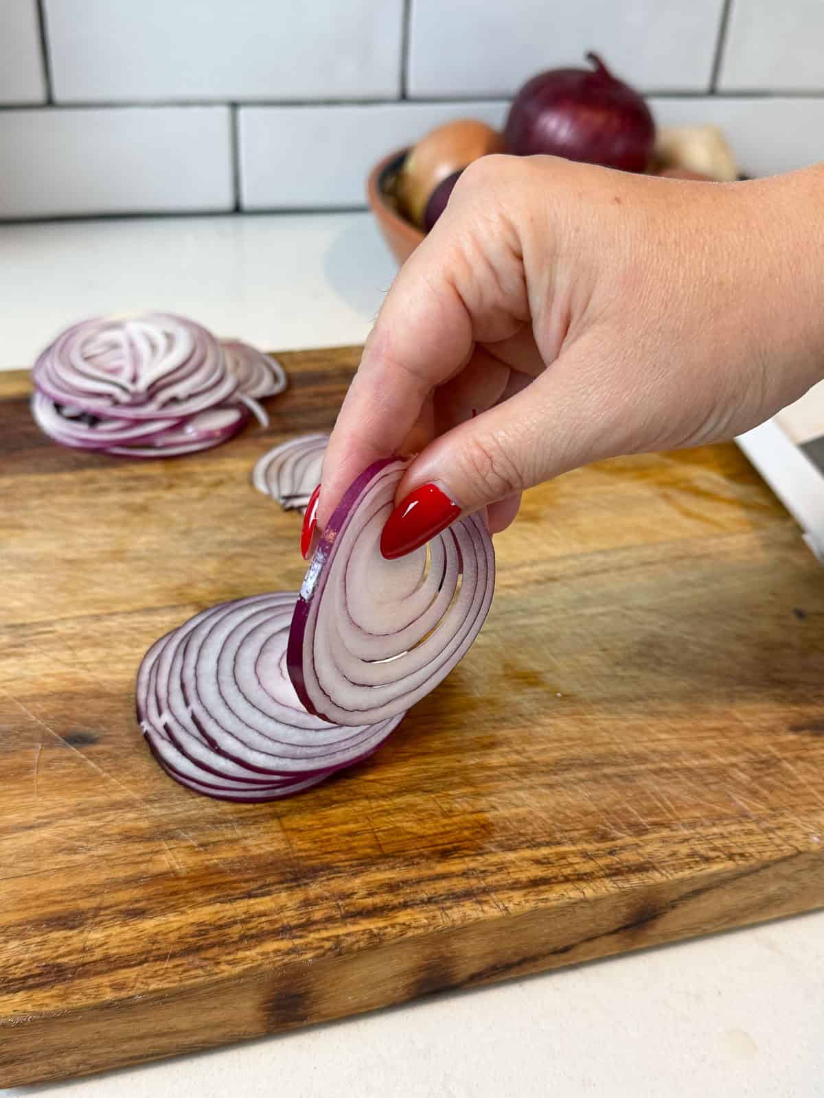 Thinly slice red onions using a knife or mandolin.